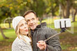 Smiling young couple taking selfies