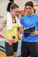 Trainer and woman discussing workout plan