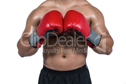 Muscular man boxing in gloves
