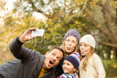 Smiling young family taking selfies