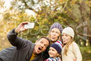 Smiling young family taking selfies