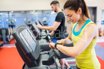 Couple using treadmills together