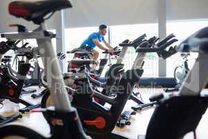 Focused man on exercise bikes