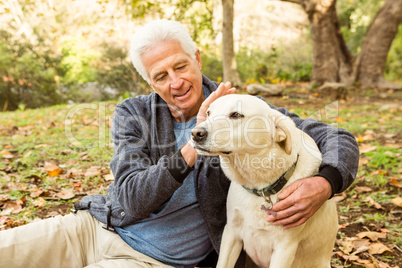 Senior man with his dog in park