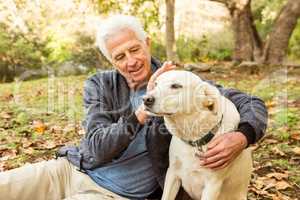 Senior man with his dog in park