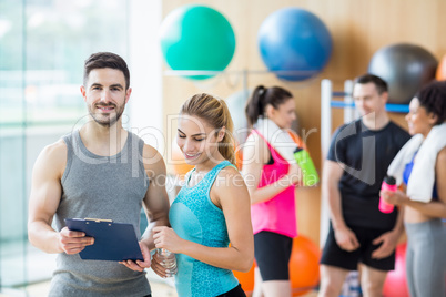 Client and trainer looking at clipboard