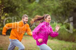 Happy couple running on a hike