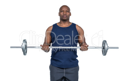 Fit man lifting heavy barbell