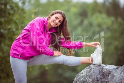 Fit woman stretching her leg