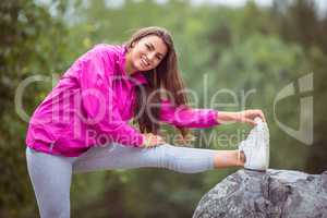 Fit woman stretching her leg