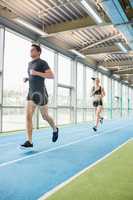 Couple running on the indoor track