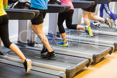 Fit people jogging on treadmills