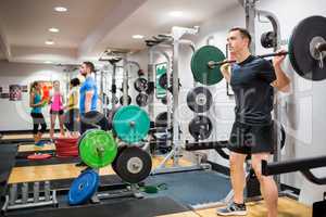 Fit people working out in weights room