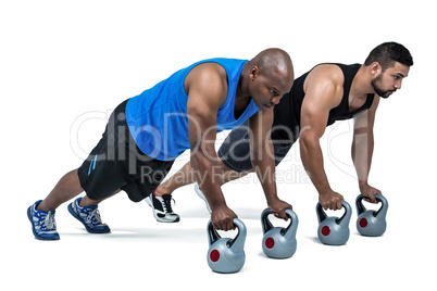 Strong friends using kettlebells together