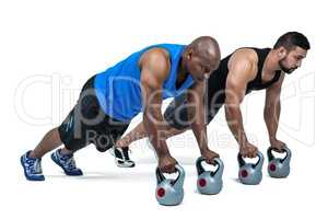 Strong friends using kettlebells together
