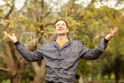 Young handsome man with raised arms