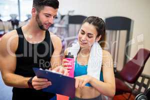 Trainer explaining workout regime to woman