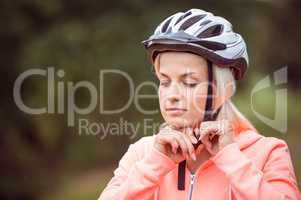 Woman fastening her bike helmet