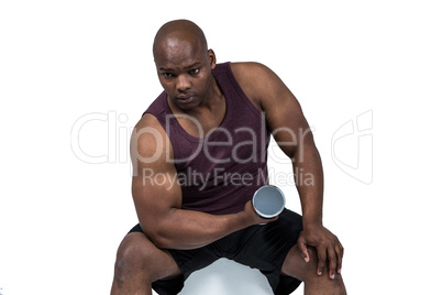 Fit man exercising with dumbbells