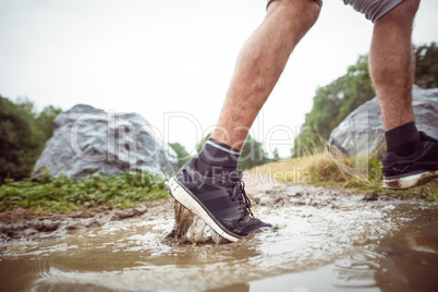 Man walking in muddy puddles