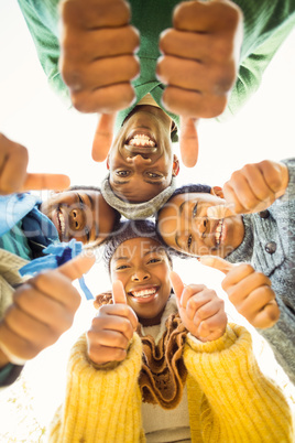 Young family doing a head circles with thumbs up