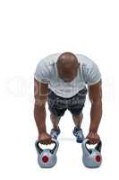 Fit man exercising with kettlebell