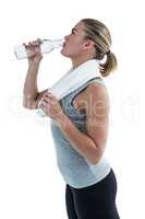 Fit woman drinking water