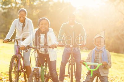 Young smiling family doing a bike ride