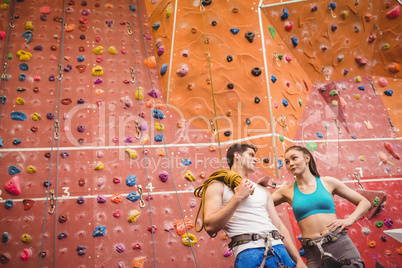 Fit couple at the rock climbing wall