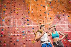 Fit couple at the rock climbing wall