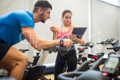 Trainer timing man on exercise bike