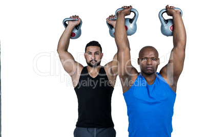 Strong friends lifting kettlebells together