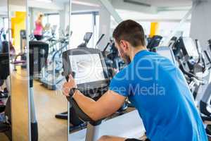 Fit man using the exercise bike