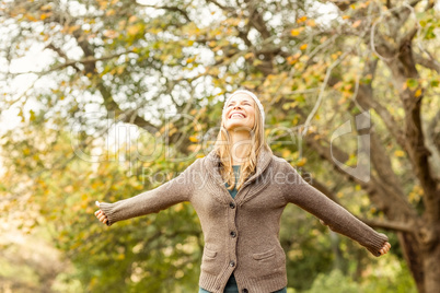 Smiling woman with arms outstretched