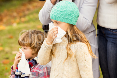 Sick family blowing their noses