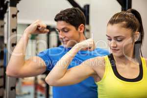 Happy couple showing off their biceps