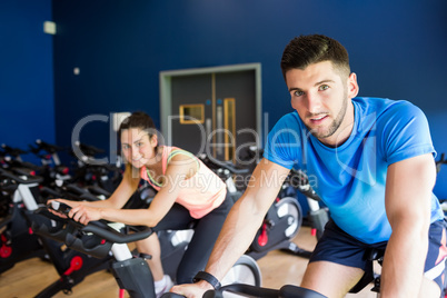 Man and woman using cycling exercise bikes