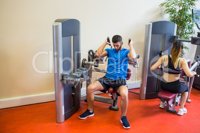 Fit man and woman working out