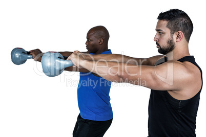 Strong friends lifting kettlebells together