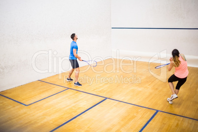 Couple playing a game of squash