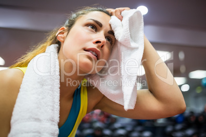 Woman drying her forehead from a workout