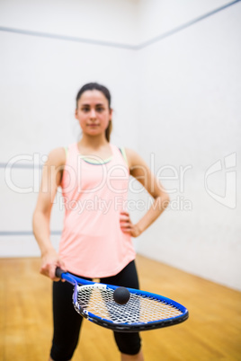 Woman balancing a ball on her racket