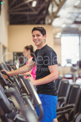 Fit people working out using machines