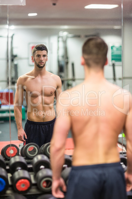 Man standing in front of large mirror