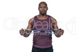 Fit man exercising with resistance band
