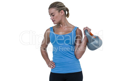 Muscular woman exercising with dumbbells