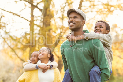 Portrait of a young smiling family in piggyback