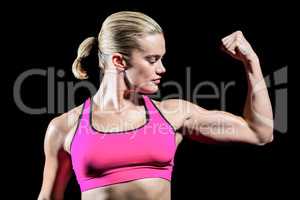 Muscular woman flexing her arm