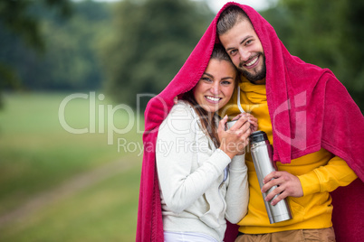 Happy couple under a blanket