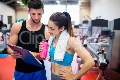 Trainer explaining workout regime to woman